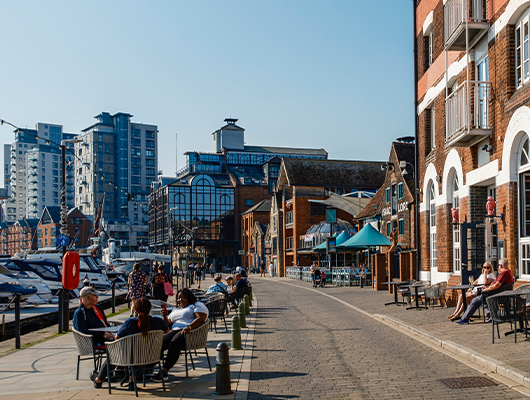 People outside a cafe on the waterfront in Neptune Marina, Ipswich